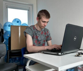 Uczeń pracuje na laptopie podczas praktyk zawodowych w portugalskiej firmie.